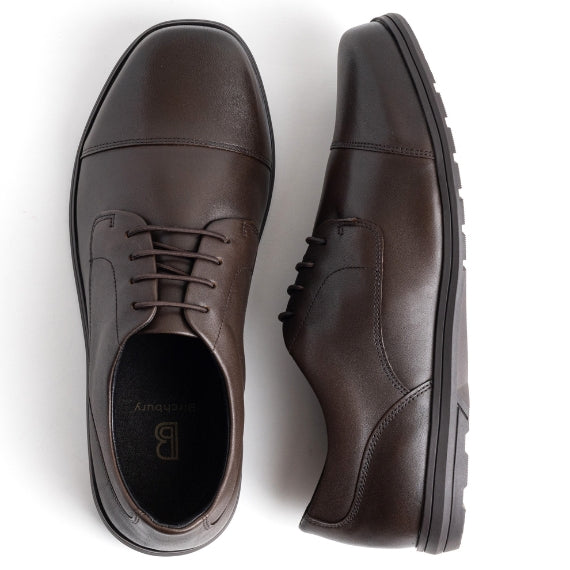 Brown leather dress shoes with laces, viewed from above.